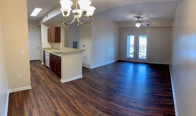 an empty living room and kitchen with wood flooring