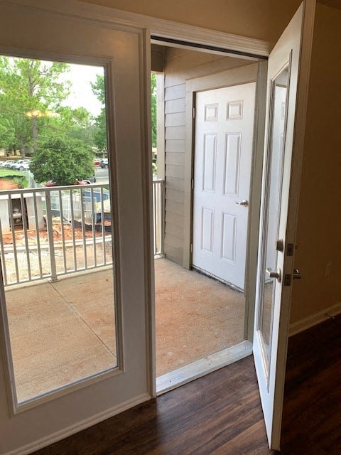 an open door leading to a balcony with a white door