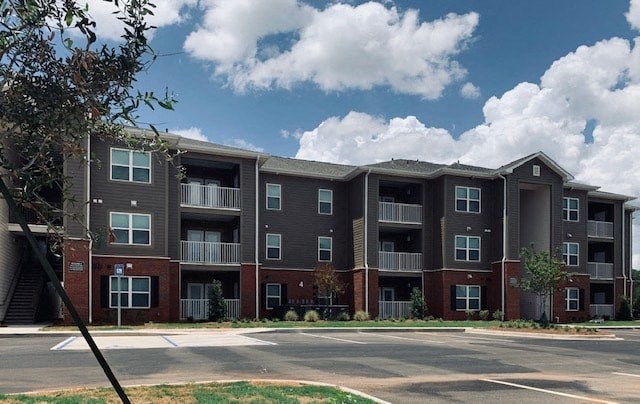 an apartment building with an empty parking lot