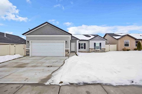a house with a driveway and a garage door in front of it