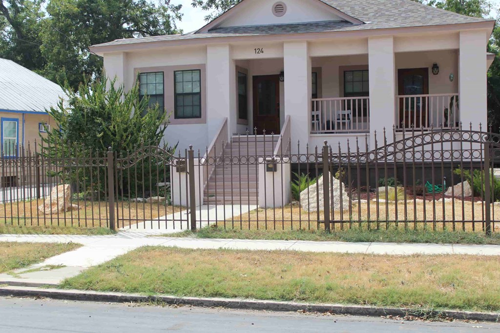 a house with a wrought iron fence in front of it