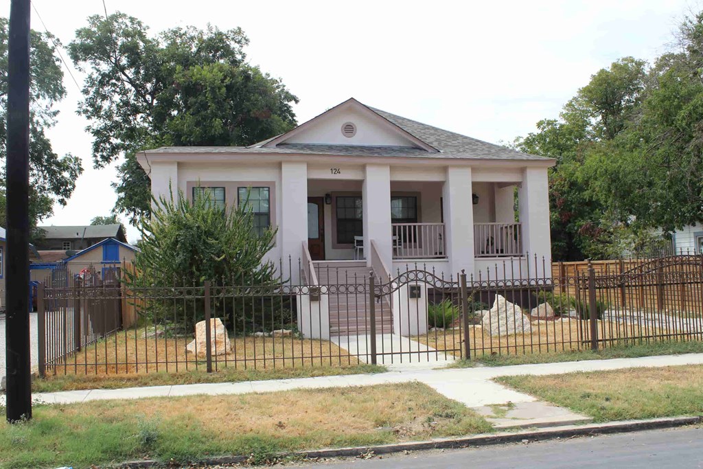 a small house with a fence in front of it