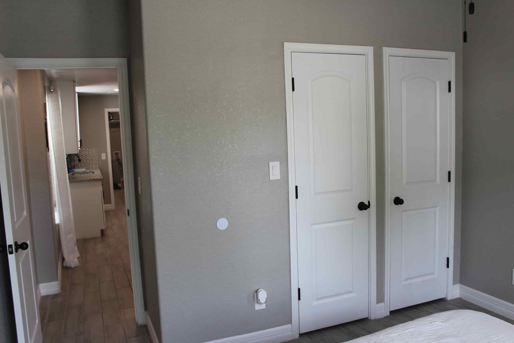 a bedroom with two closets and a bed and a hallway