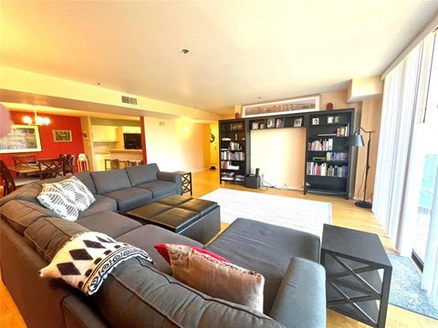 a large living room with a couch and a table