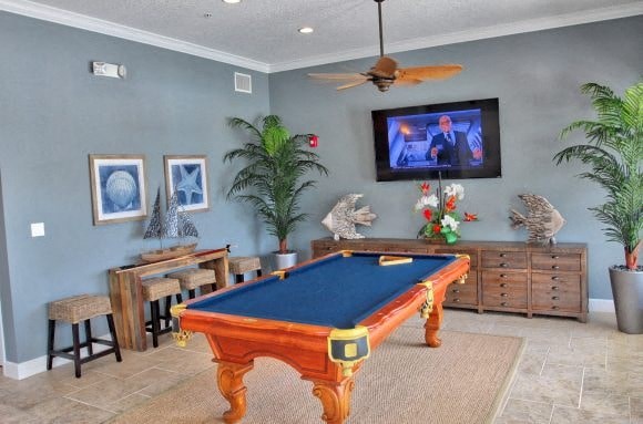 a living room with a pool table and a tv