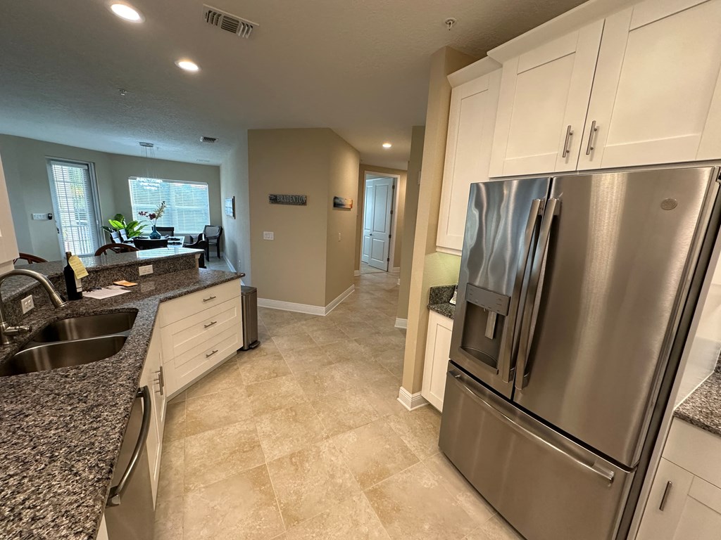 a kitchen with stainless steel appliances and granite counter tops