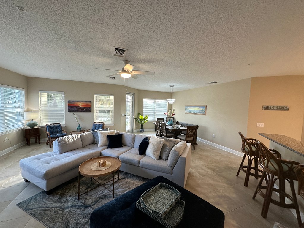 a living room and dining room with a couch and a table