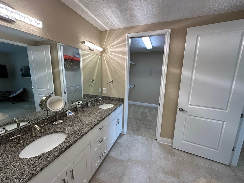 a bathroom with two sinks and a mirror