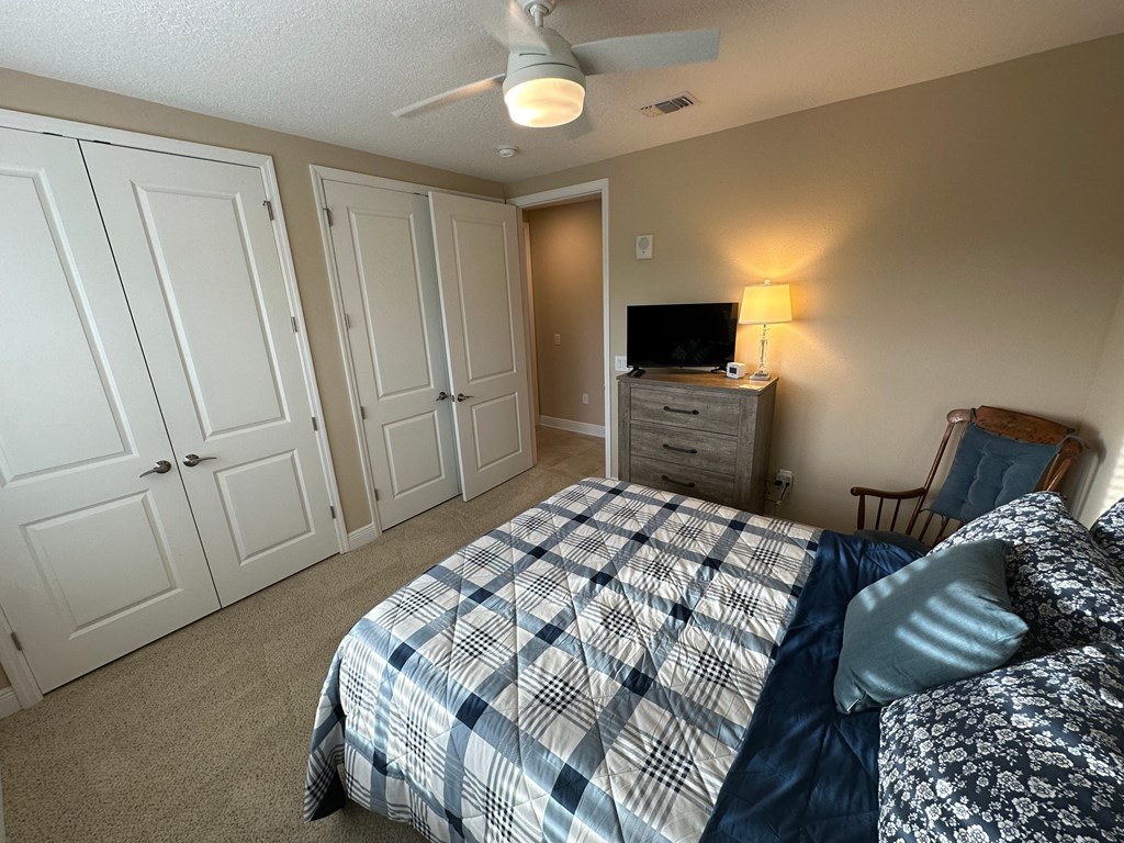 a bedroom with a bed and a tv