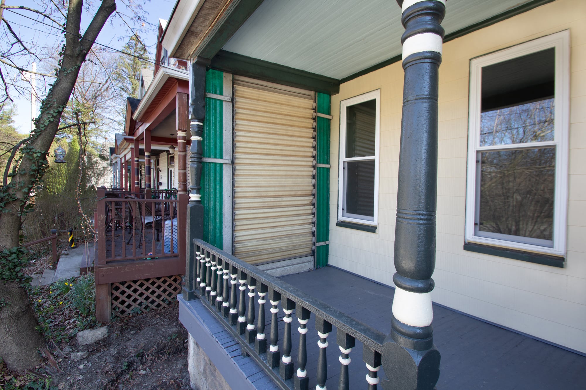 the front porch of a house with a wooden railing