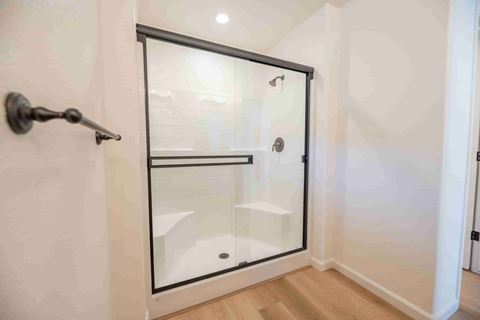 a shower in a small bathroom with a glass door