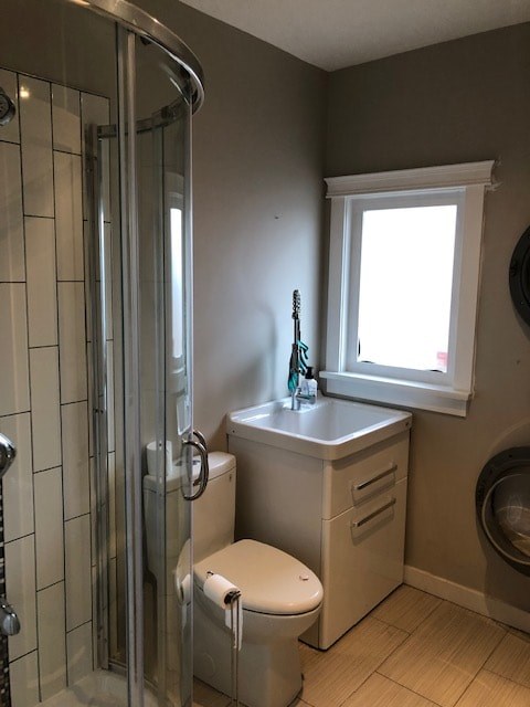 a bathroom with a toilet and a shower