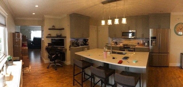 a kitchen with a bar and a counter top