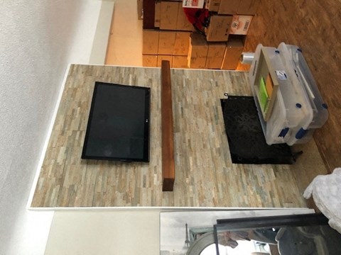 an aerial view of a living room with a tv and a table