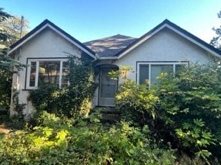 a house with a lot of bushes in front of it