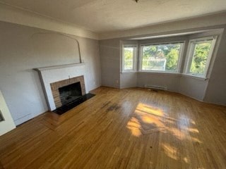 a living room with a wood floor and a fireplace