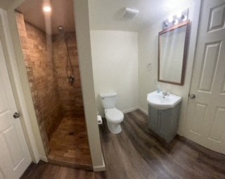 a bathroom with a toilet and a sink and a shower
