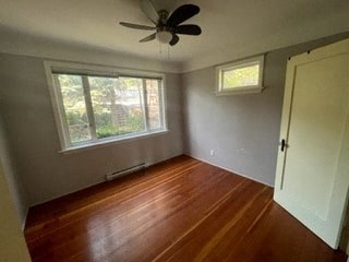 a empty room with a ceiling fan and a wood floor