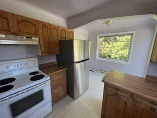 a kitchen with a stove and a refrigerator