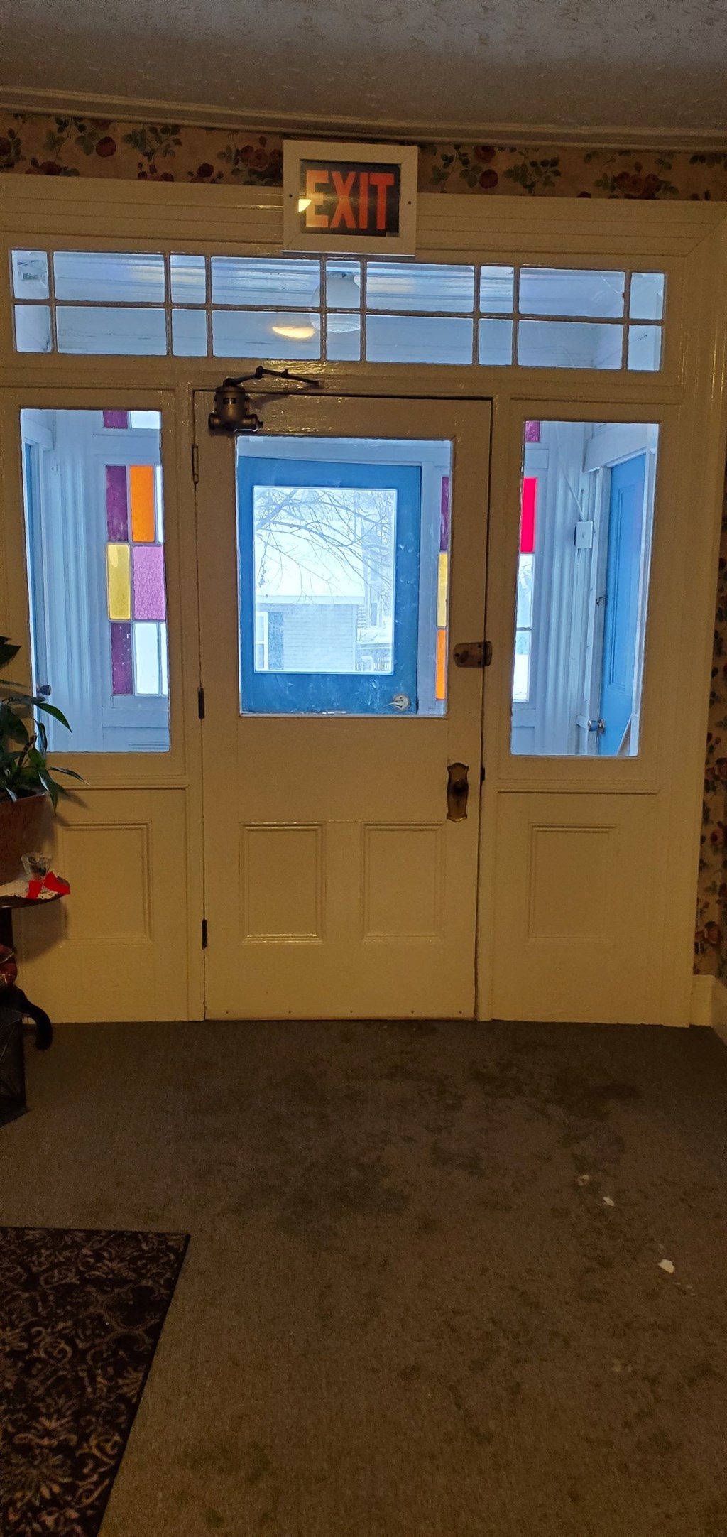 a set of double doors with a window and a exit sign