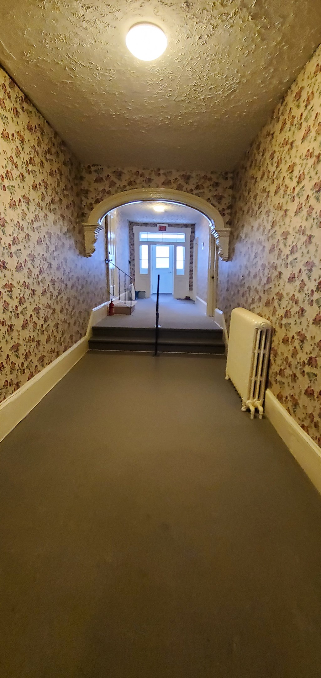 a room with a bed and a radiator in it