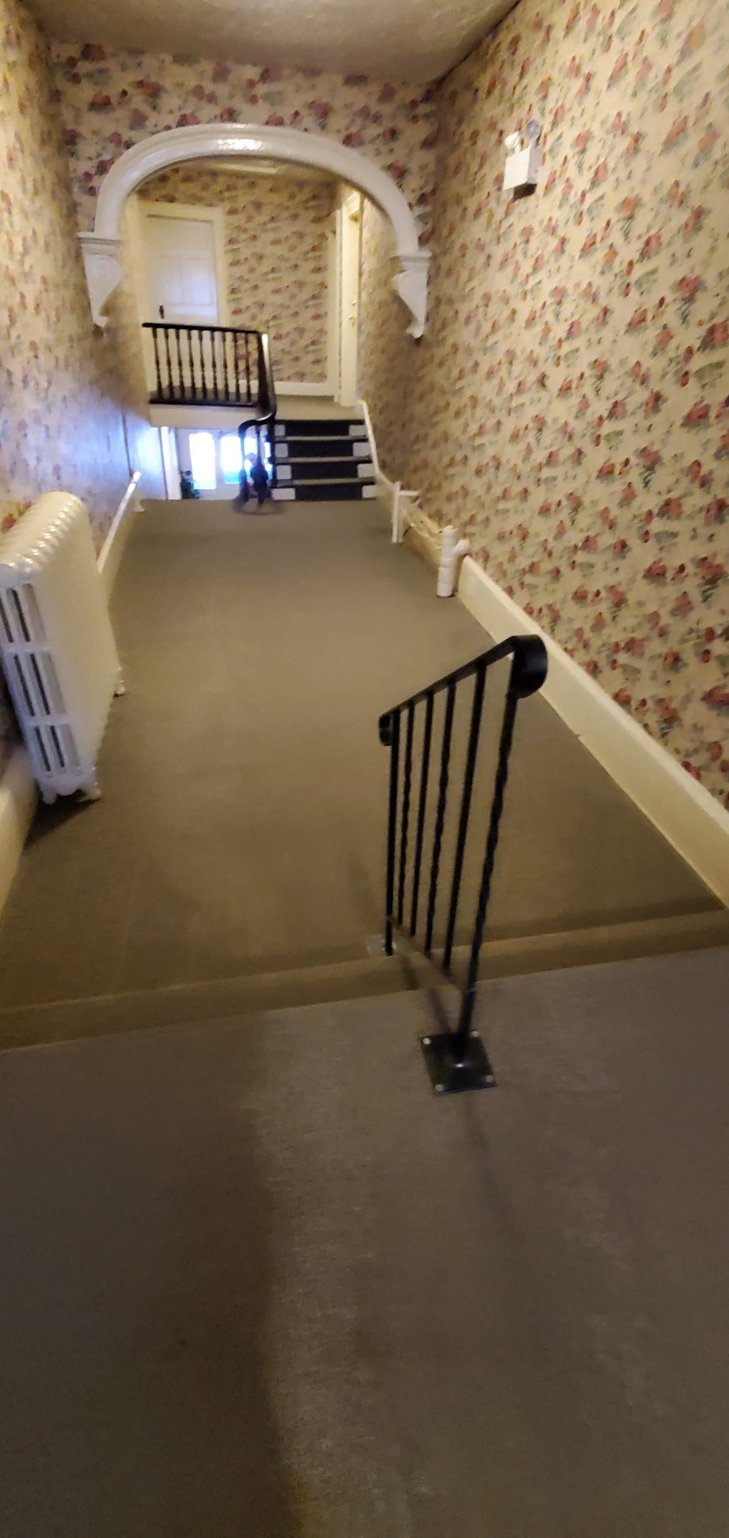 the stairs in the basement of a house with wallpaper on the walls