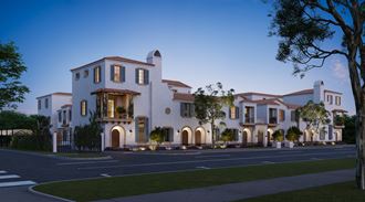 a rendering of a luxury home on a street at dusk