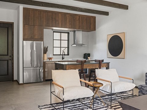 A modern kitchen with a wooden cabinet and a fridge.
