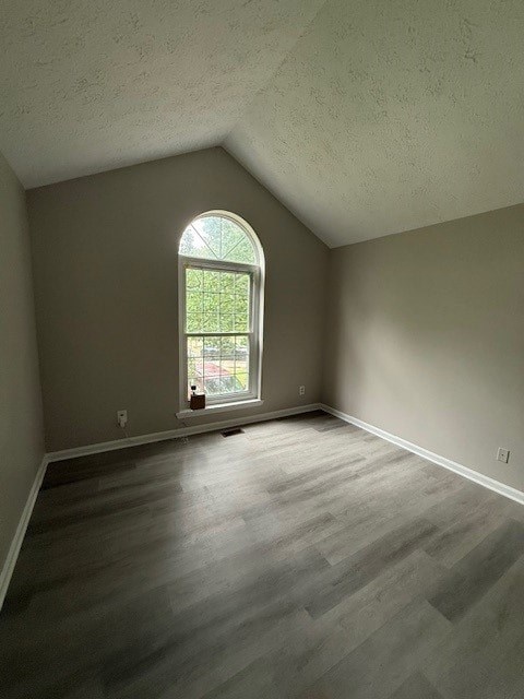 A room with a window and wooden flooring.