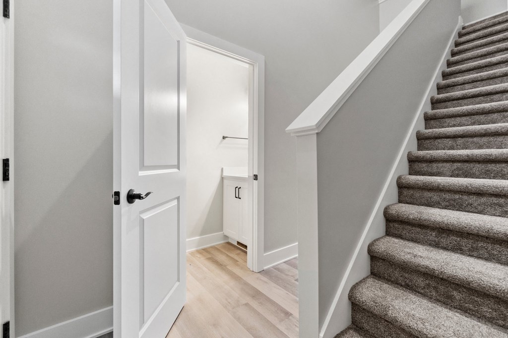 a staircase in a home with stairs and a door to a closet