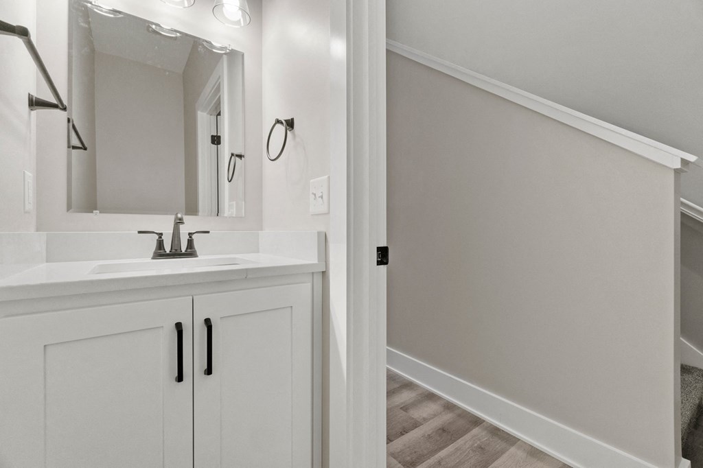 a white bathroom with a sink and a mirror