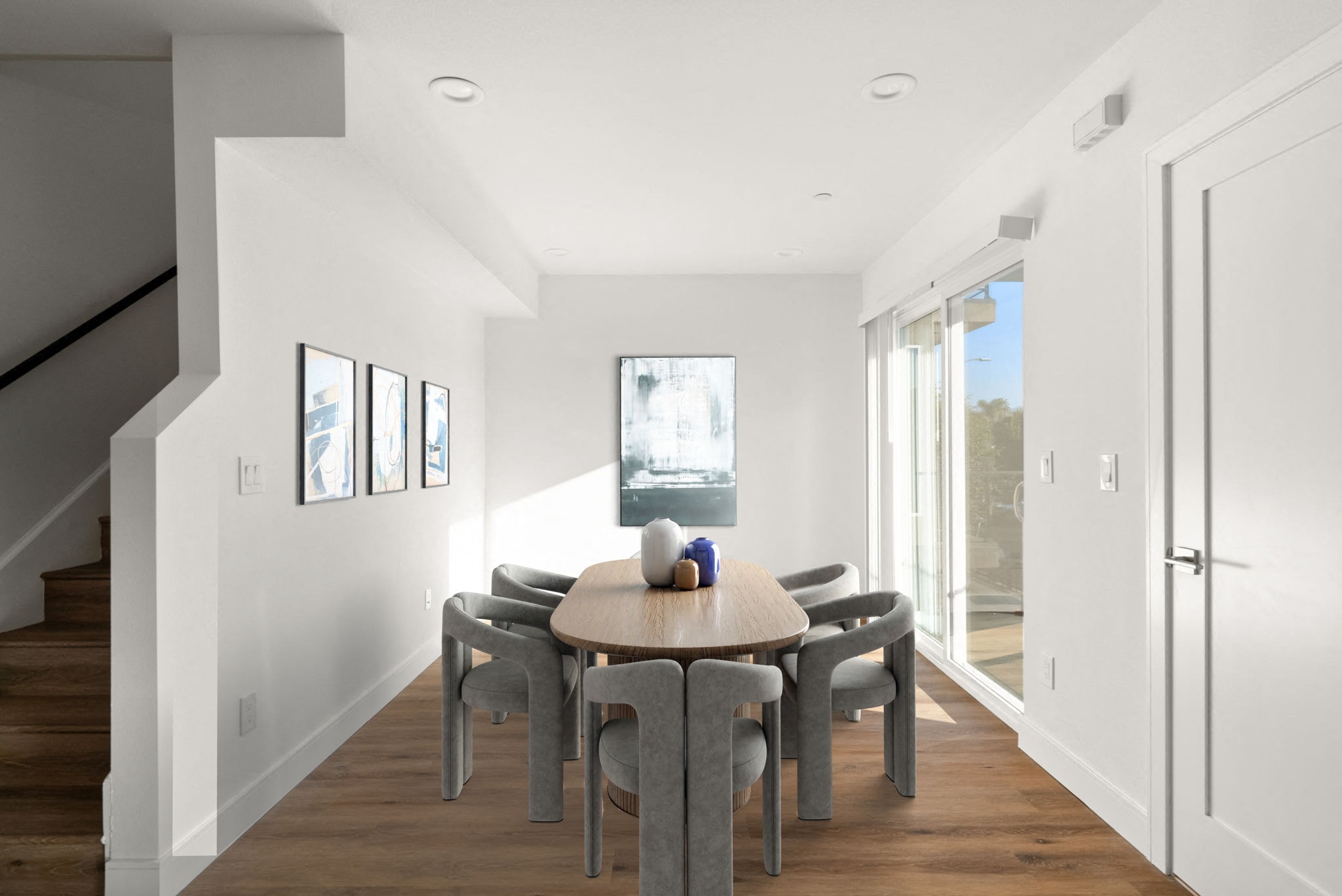 a dining room with a wooden table and chairs