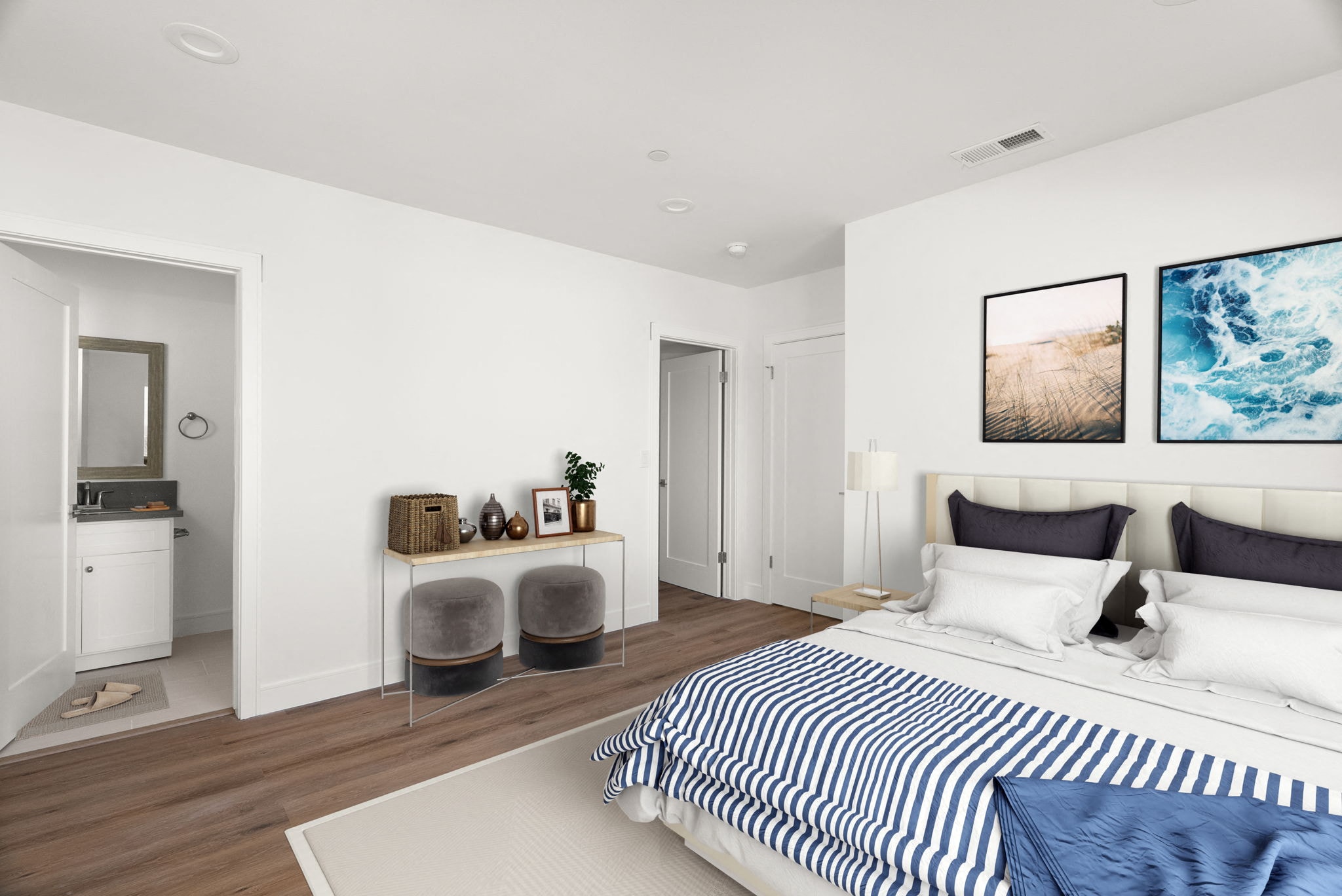 A modern bedroom with a large bed and a kitchen area.