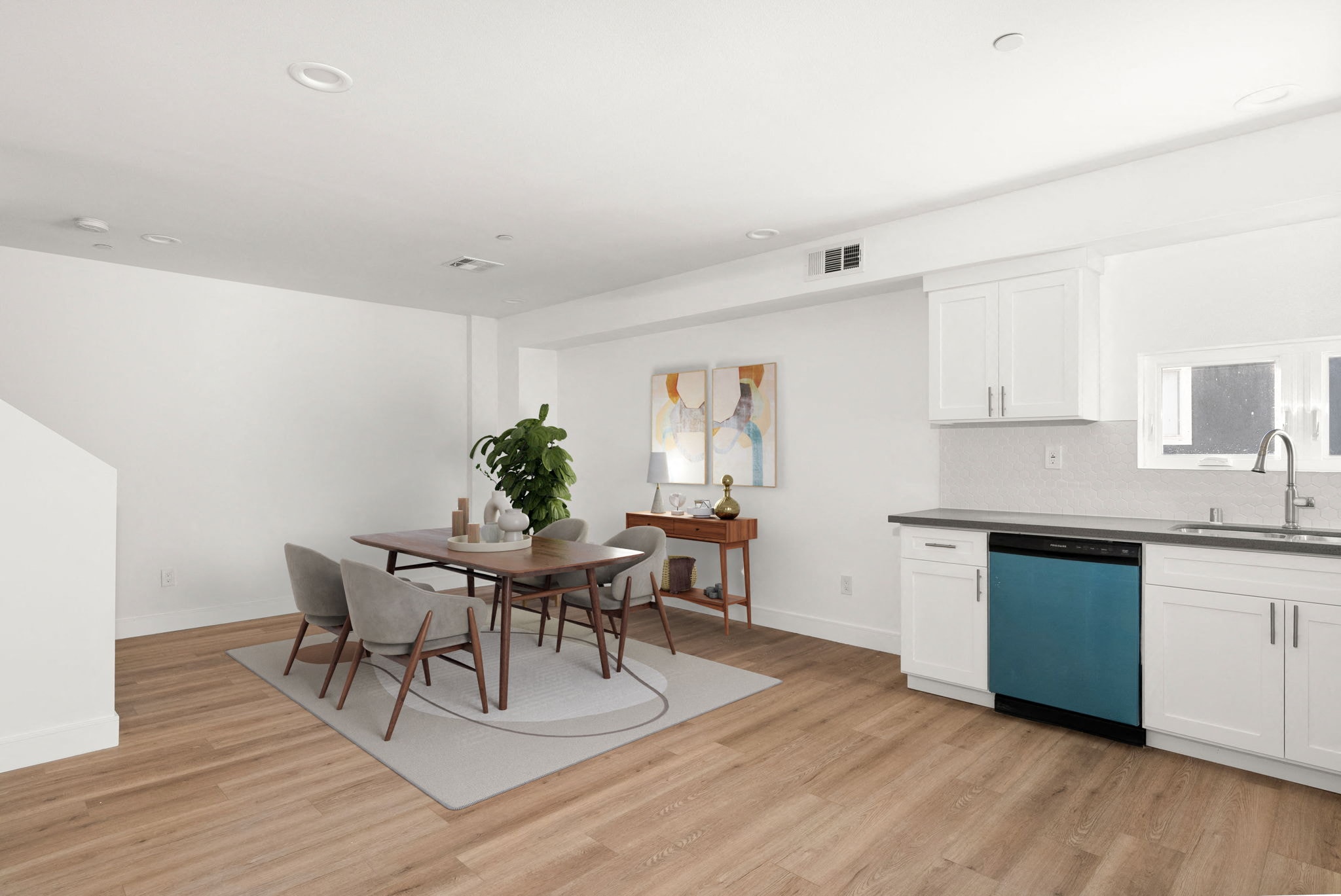 A dining room with a table and chairs.