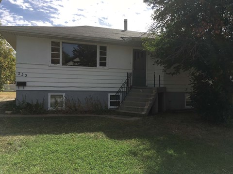 the front of the house with the stairs up to it