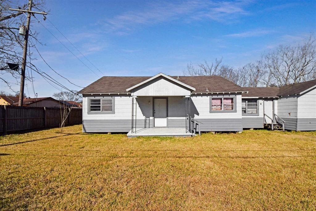 a small white house with a yard in front of it