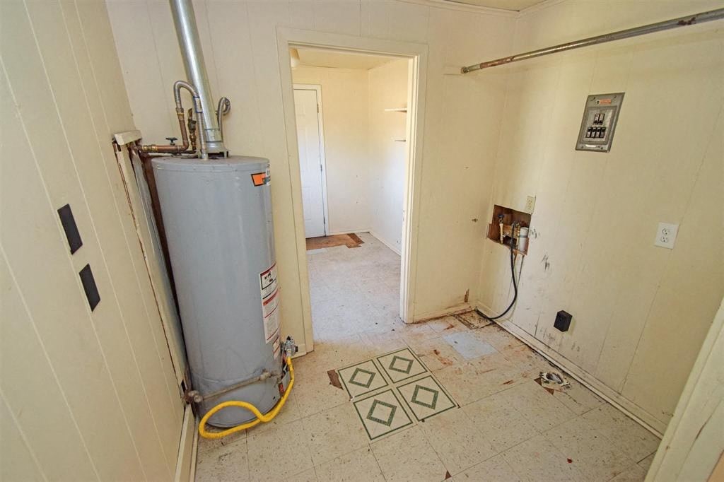an empty room with a water heater in it
