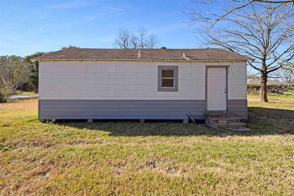 a tiny house on the side of a field