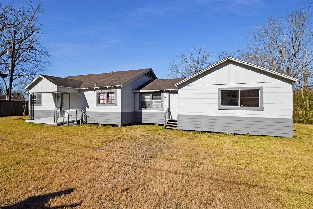a white house and a gray house in a field