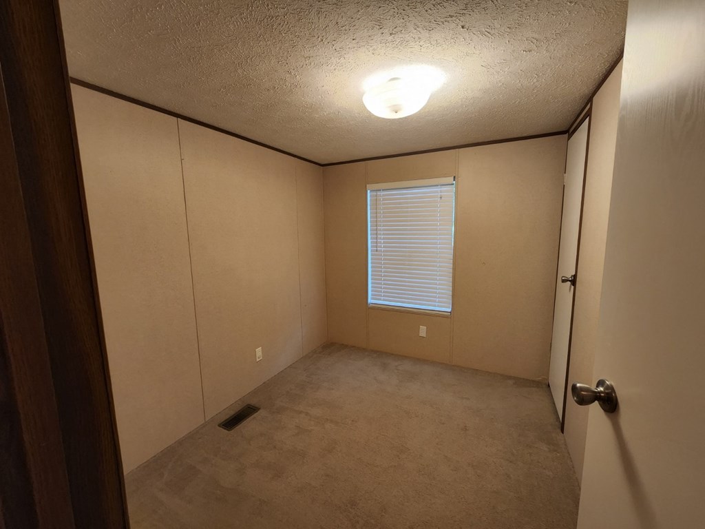 the view of a room with a door and a window