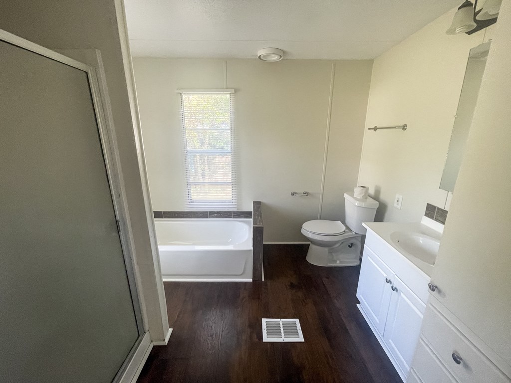 a small bathroom with a toilet and a tub and a sink