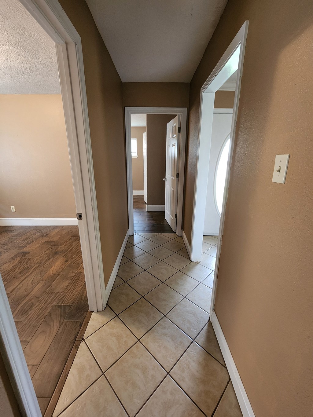 a view of the living room and dining room from the hallway