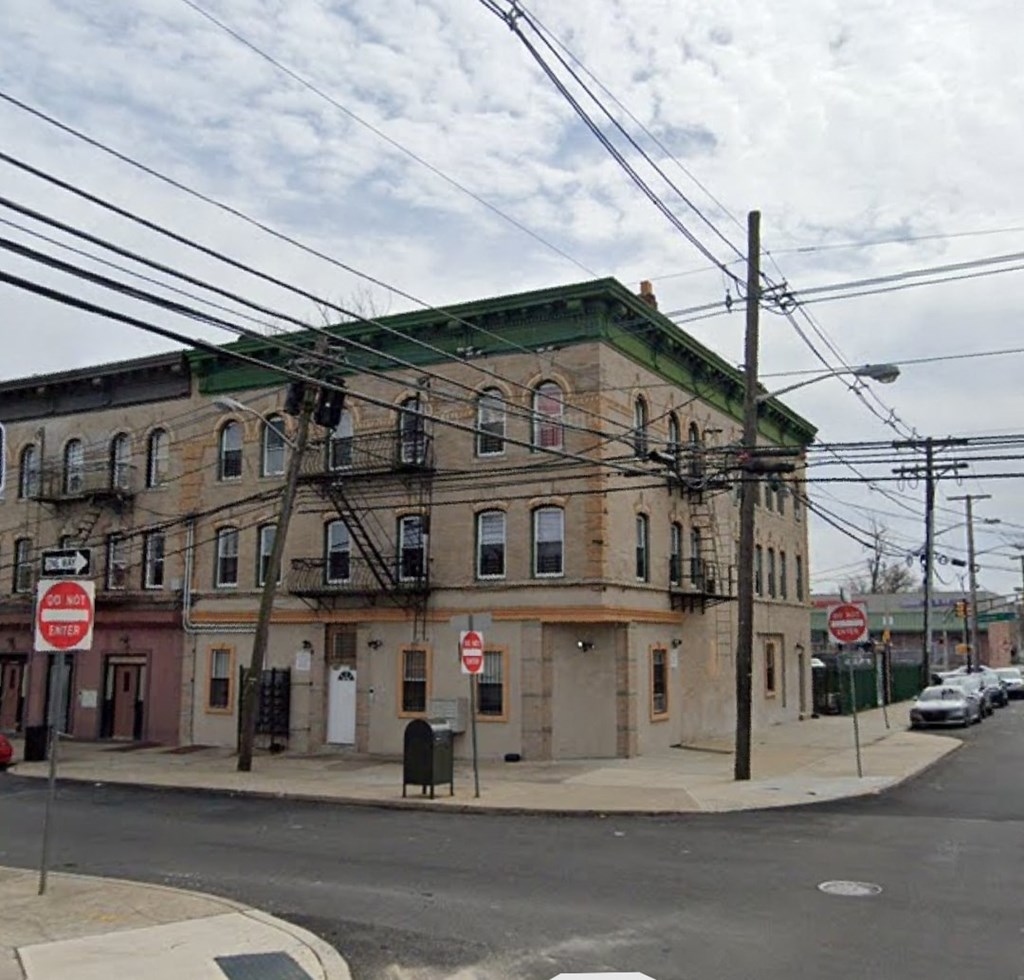 an old building on the corner of a city street