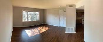 A room with wooden floors and a large window.