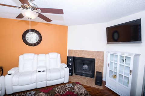 a living room with a white couch and a fireplace