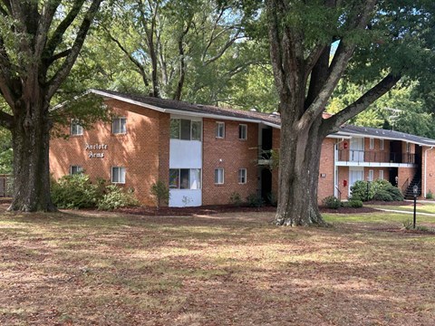 A brick building with the words "Apartments" written on the front.