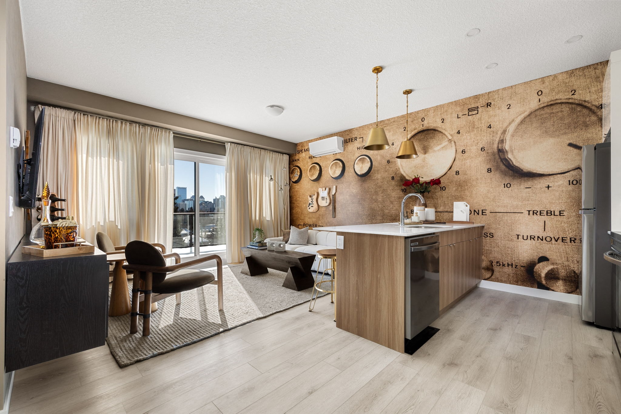 A modern kitchen with a wooden island and a dining area with a table and chairs.