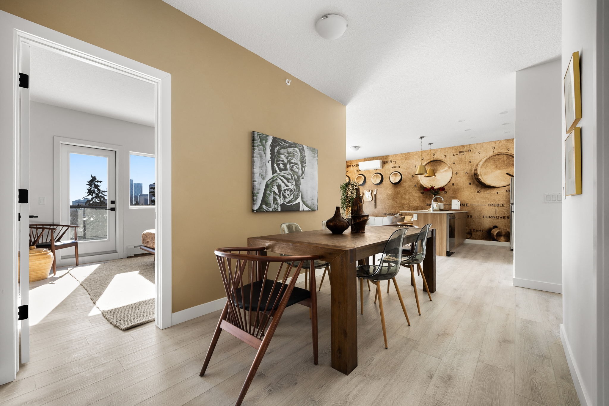 A dining room with a wooden table and chairs.