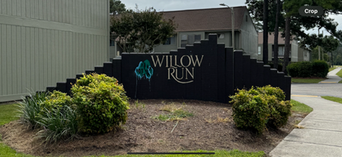 a sign for willow run in front of a building