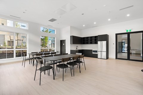 A modern dining room with a long table and chairs.